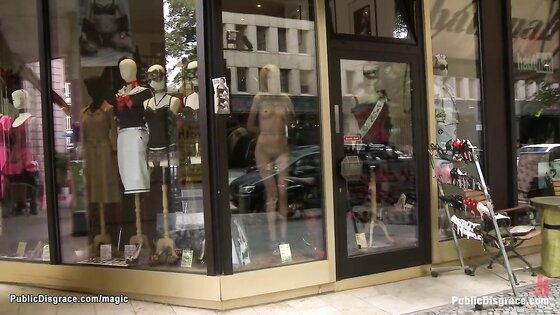 Naked blonde bound in shop window