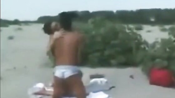 Two lesbians finger and lick each other on the beach