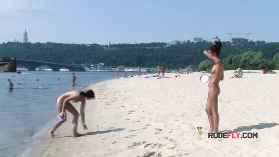 Bombastic young nudist babes sunbathe nude at the beach