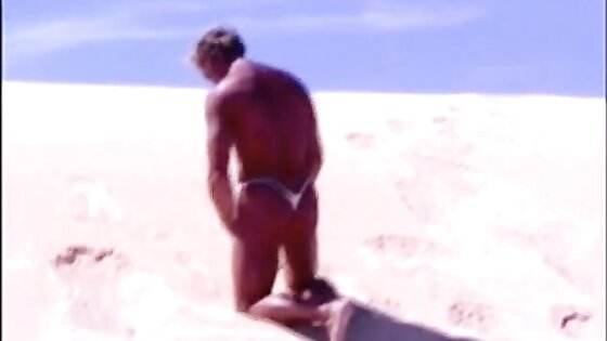 Tanned guy on beach in tiny string thong (temporarily!)