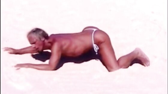 Tanned guy on beach in tiny string thong (temporarily!)