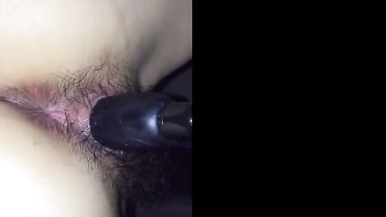 Hairy Japanese girl with a toy in her pussy