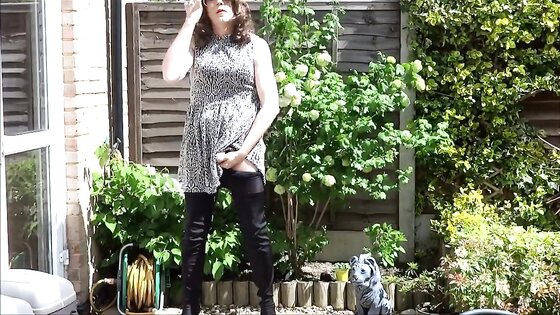 Sexy masturbating crossdresser in thigh boots outdoors