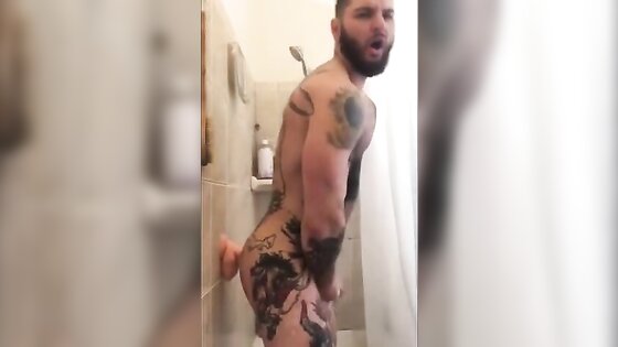 Tatted Hunk Fucks Dildo in Shower Until He Cums