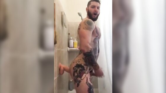 Tatted Hunk Fucks Dildo in Shower Until He Cums